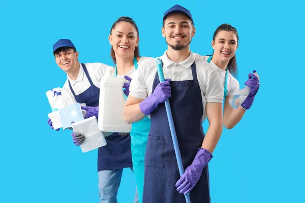 Jovens Zeladores Com Suprimentos Limpeza Fundo Azul — Fotografia de Stock