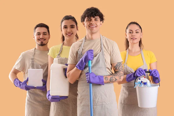Young Janitors Cleaning Supplies Beige Background — Stock Photo, Image