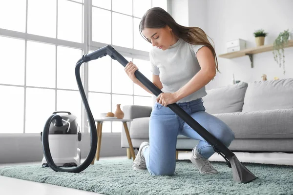 Young Woman Vacuuming Carpet Home — Foto de Stock