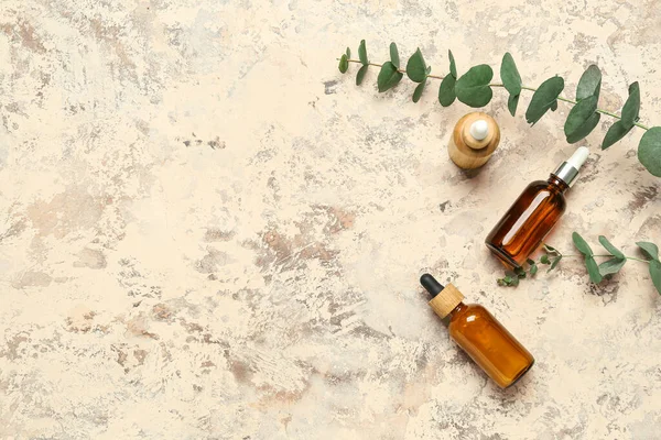 Bottles Cosmetic Oil Eucalyptus Branches Textured Background — Stock Photo, Image