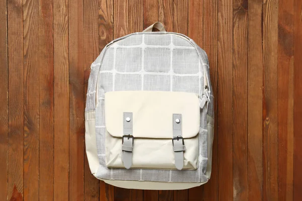 stock image Grey school backpack on wooden background