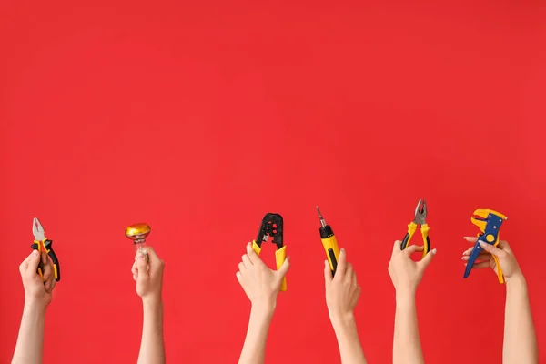 Electrician Hands Tools Light Bulb Red Background — Stok fotoğraf
