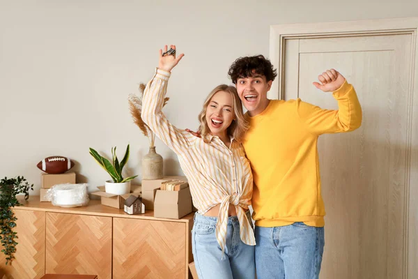 Happy young couple in room on moving day