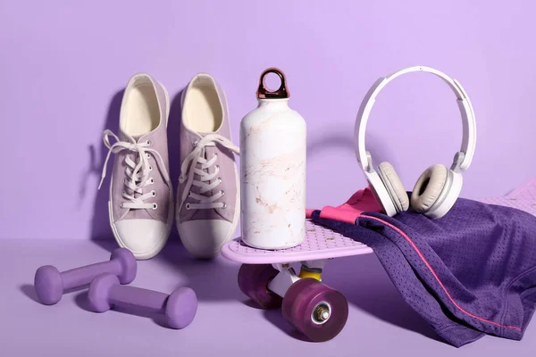 Composition Different Sports Equipment Shoes Bottle Water Lilac Background — Stock Photo, Image