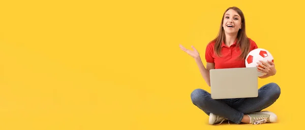 快乐的年轻女子 带着足球和笔记本电脑 背景是黄色的 有文字空间 — 图库照片