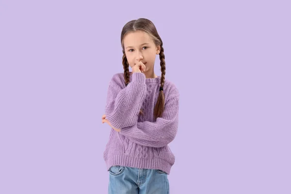 Little Girl Biting Nails Lilac Background — Fotografie, imagine de stoc