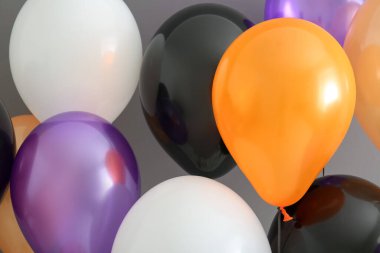 Gri arkaplanda farklı Cadılar Bayramı balonları, yakın plan