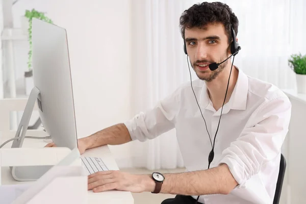 Male technical support agent  working in office