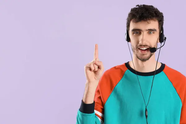 Male Technical Support Agent Pointing Something Lilac Background — Stock Photo, Image