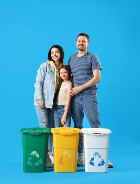 Family with recycle bins on blue background