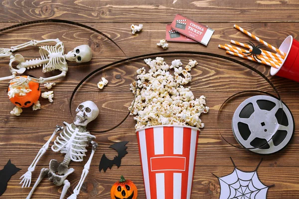 Composition Tasty Popcorn Skeletons Film Reel Cinema Tickets Wooden Background — Stock Photo, Image