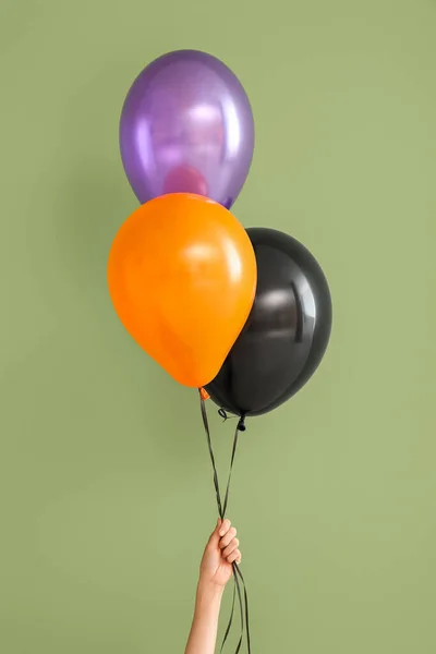 Female Hand Different Halloween Balloons Green Background — Stock Photo, Image