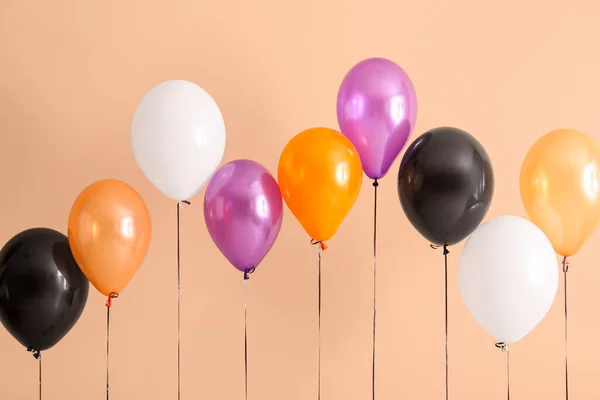 Different Halloween Balloons Beige Background — Stock Photo, Image