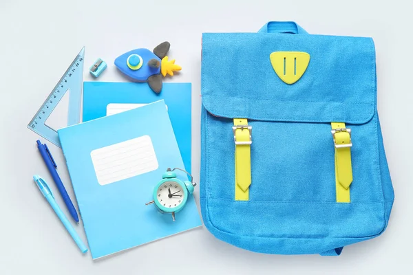 stock image Backpack with rocket made of plasticine, alarm clock and stationery on grey background