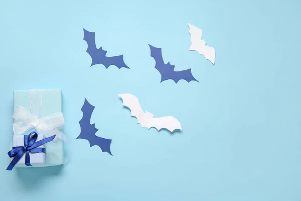 Stock image Composition with beautiful gift boxes and bats made of paper for Halloween on blue background