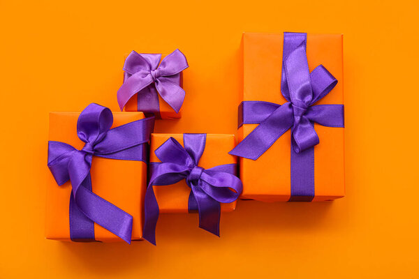 Beautiful gift boxes for Halloween on orange background