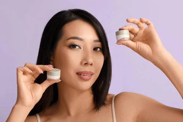 Beautiful Young Asian Woman Facial Creams Lilac Background — Stock Photo, Image