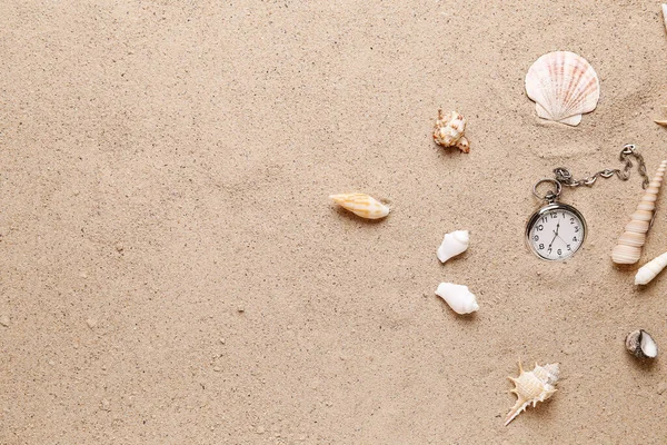 stock image Pocket watch and seashells on sand background