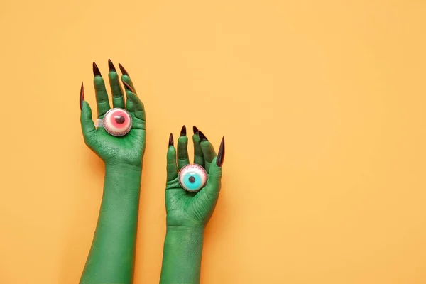 Green Hands Witch Eyes Orange Background Halloween Celebration — Stock Photo, Image