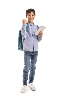 Happy little schoolboy with tablet computer on white background