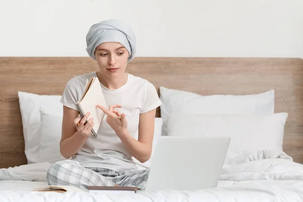 stock image Teenage girl after chemotherapy studying online in bedroom