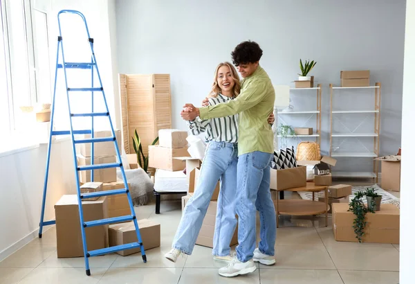 Young couple dancing in bedroom on moving day