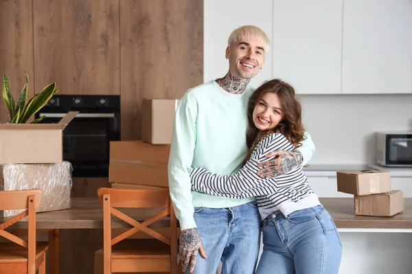 Young couple hugging in kitchen on moving day