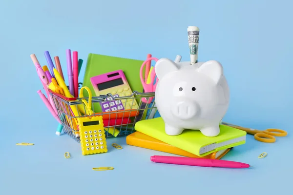 Shopping Basket Full Different Stationery Piggy Bank Money Blue Background — Stock Photo, Image