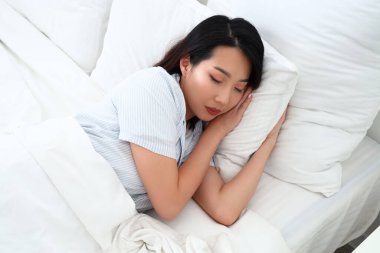 Beautiful Asian woman sleeping in bed