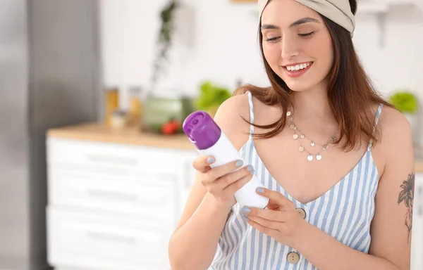 stock image Young woman with air freshener in kitchen, closeup