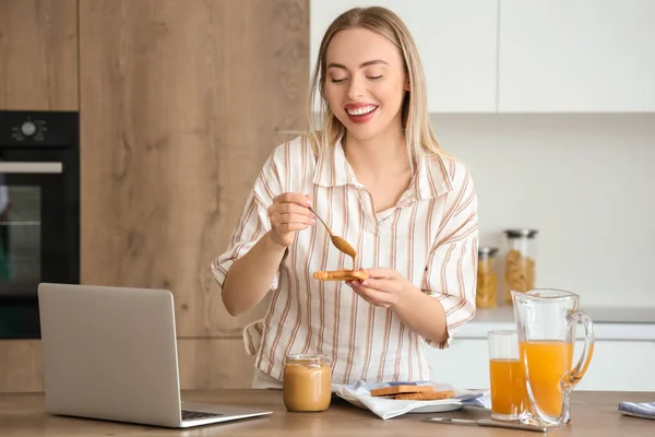 Young Woman Spreading Tasty Nut Butter Toast Kitchen — Stock Photo, Image