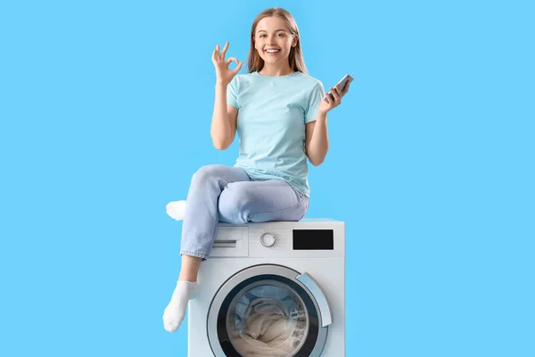 Mulher Bonita Sentada Máquina Lavar Roupa Segurando Telefone Celular Mostrando — Fotografia de Stock