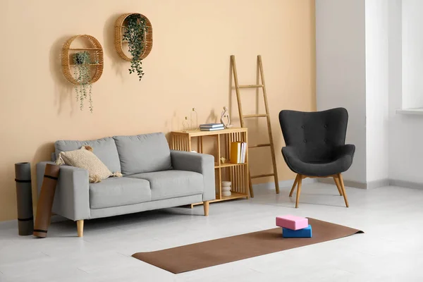 Interior of living room with sofa and yoga equipment