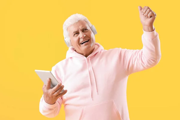 Senior Man Headphones Tablet Computer Listening Music Yellow Background — Stock Photo, Image