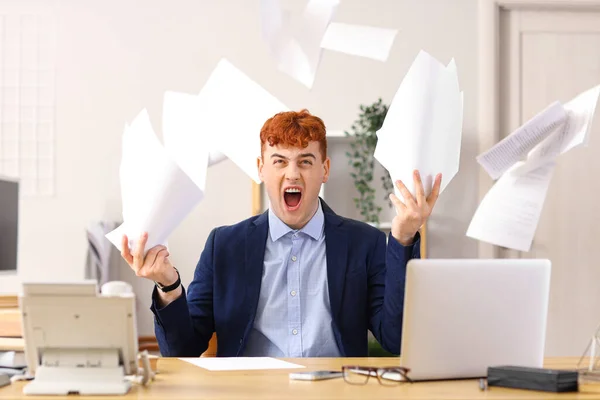 怒っている赤毛の実業家は オフィスのテーブルに紙を投げます — ストック写真