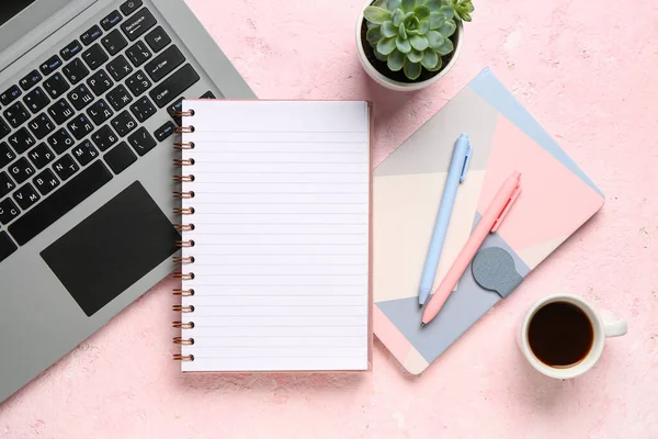 带有笔记本电脑和粉红色背景的一杯美味咖啡的笔记本 — 图库照片