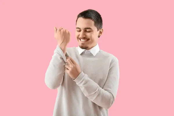 Young Man Rolling His Sleeve Pink Background — Φωτογραφία Αρχείου