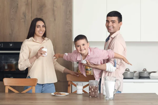 小男孩和他的父母在厨房里喝牛奶 — 图库照片