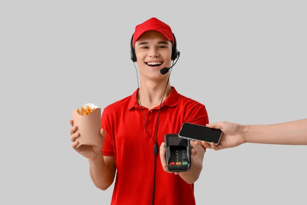 Male Worker French Fries Taking Payment Light Background — Stock Photo, Image