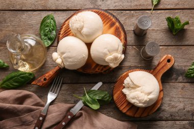 Tahta arka planda fesleğenli lezzetli Burrata peyniri tahtaları