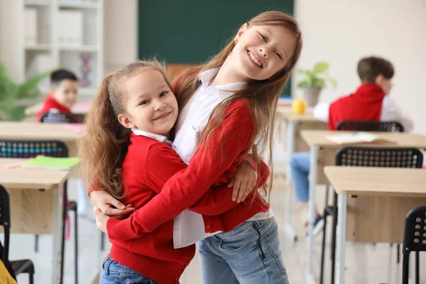 Happy Little Girls Hugging Classroom — Stock Photo, Image