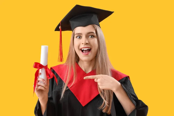 Female Graduate Student Pointing Diploma Yellow Background — Stock Photo, Image