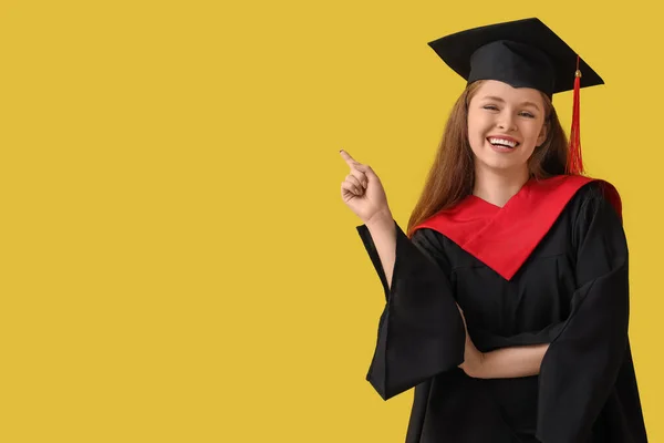 Female Graduate Student Pointing Something Yellow Background — Stock Photo, Image