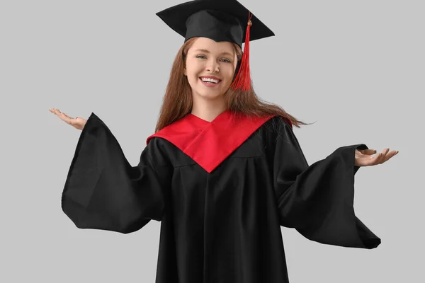 Young-Woman college graduate Student in-Graduation Dress With-Cap And  Holding Degree