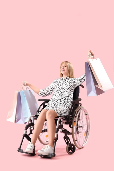 Young Woman Shopping Bags Wheelchair Pink Background — Stock Photo, Image