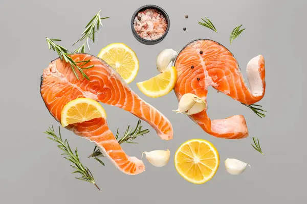 Flying Raw Salmon Steaks Different Spices Grey Background — Stock Photo, Image