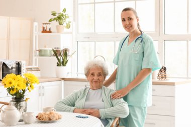 Mutfakta kadın bakıcısı olan kıdemli bir kadın.