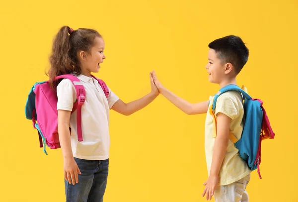 Aranyos Kis Tanulók Akik Pacsit Adnak Egymásnak Sárga Alapon — Stock Fotó