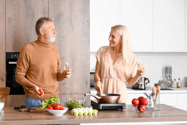 stock image Mature couple drinking champagne in kitchen