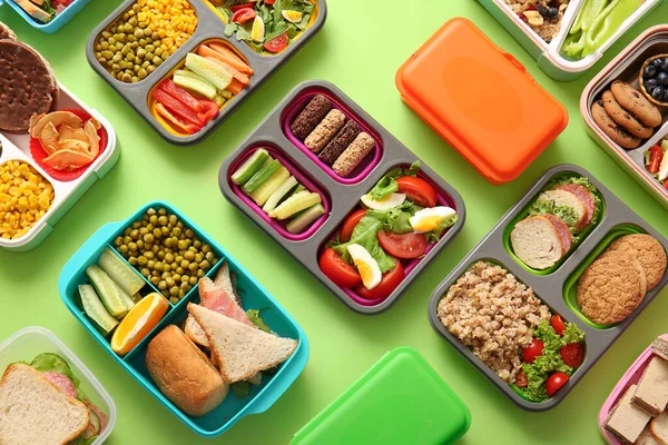 Many Lunchboxes Different Delicious Food Green Background — Stock Photo, Image